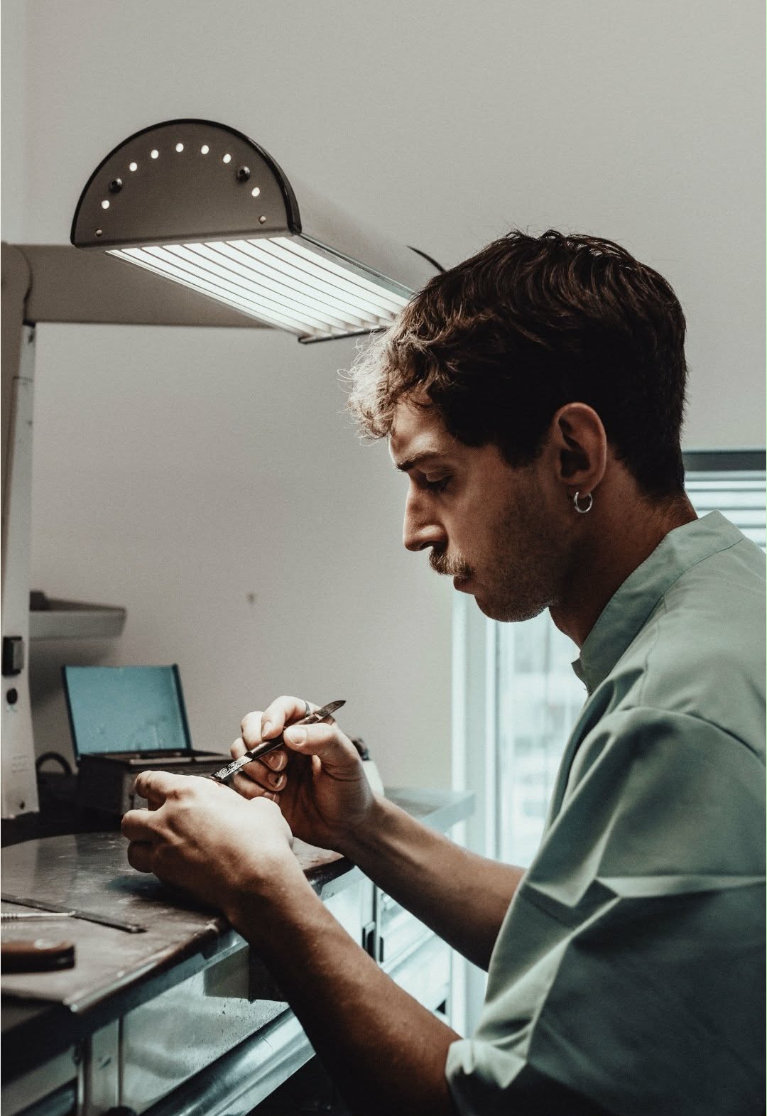 Luca working carefully at a jewellery workbench